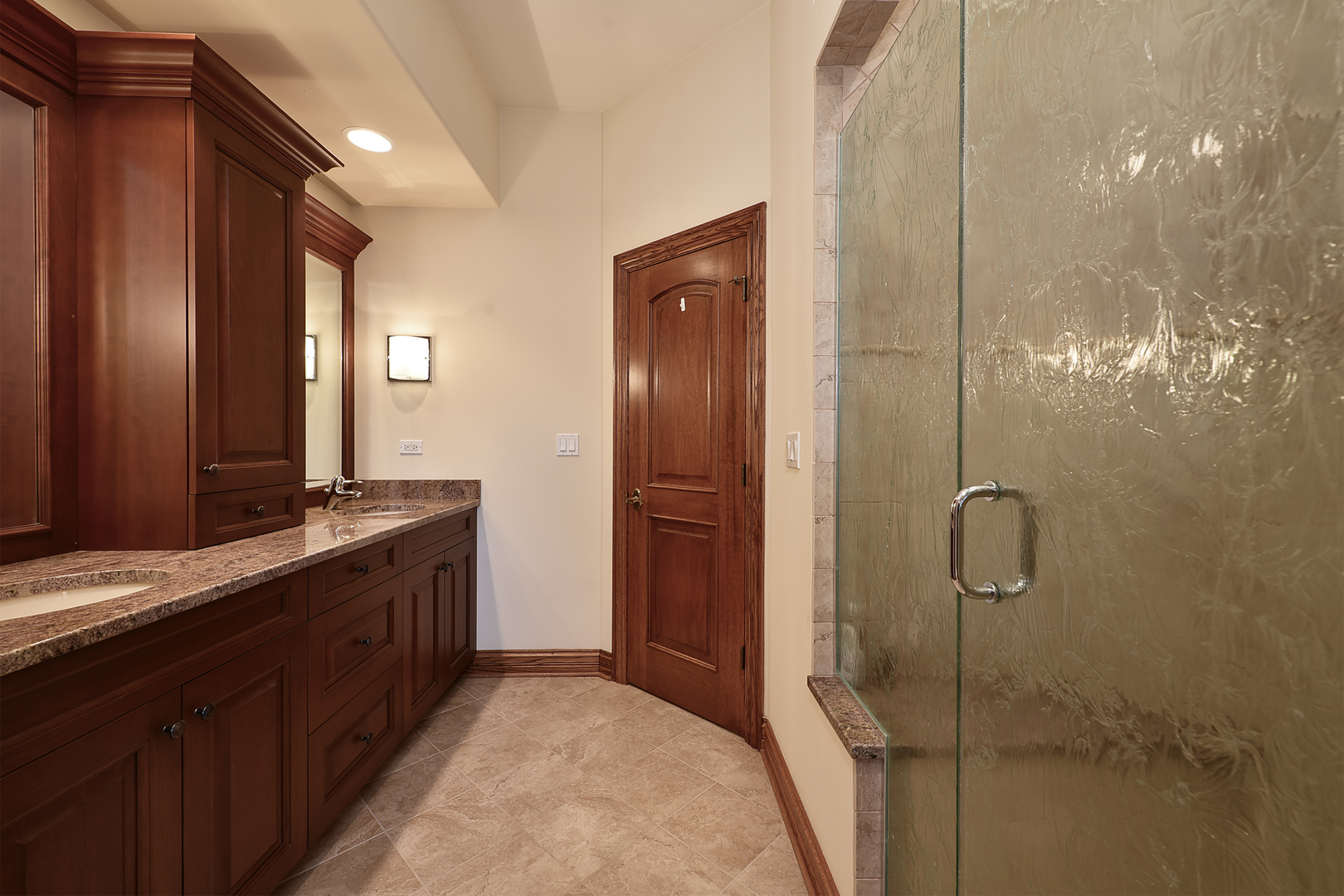10 Carnoustie Lane Inverness, IL 60067 - Photo 23 of 44 a bathroom with a mirror a double vanity sink and glass door