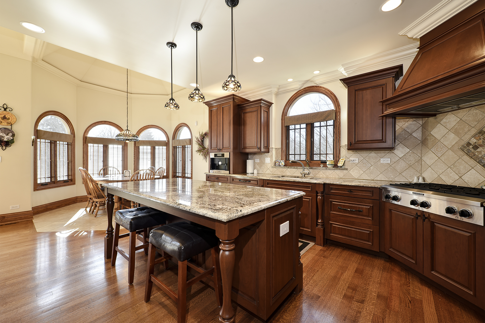 10 Carnoustie Lane Inverness, IL 60067 - Photo 5 of 44 a kitchen with stainless steel appliances granite countertop a stove a sink cabinets and wooden floor