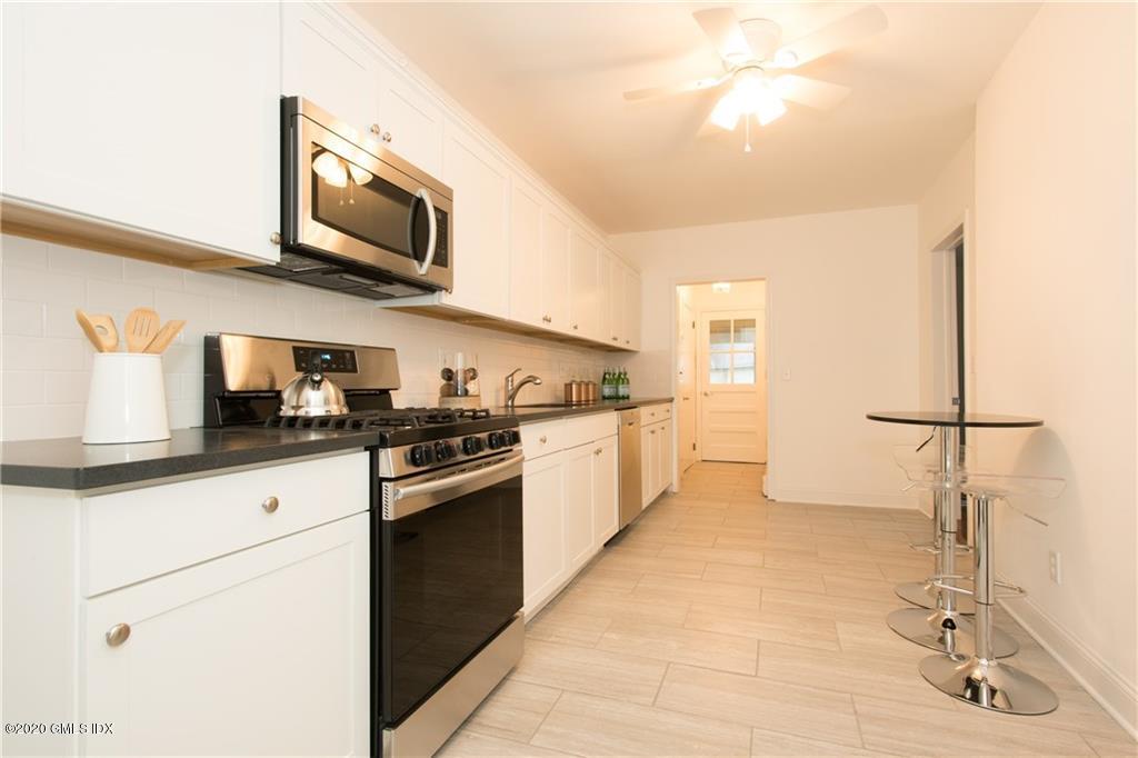25 Valley Road, Unit 25 Cos Cob, CT 06807 - Photo 6 of 17 a kitchen with stainless steel appliances granite countertop a sink and cabinets