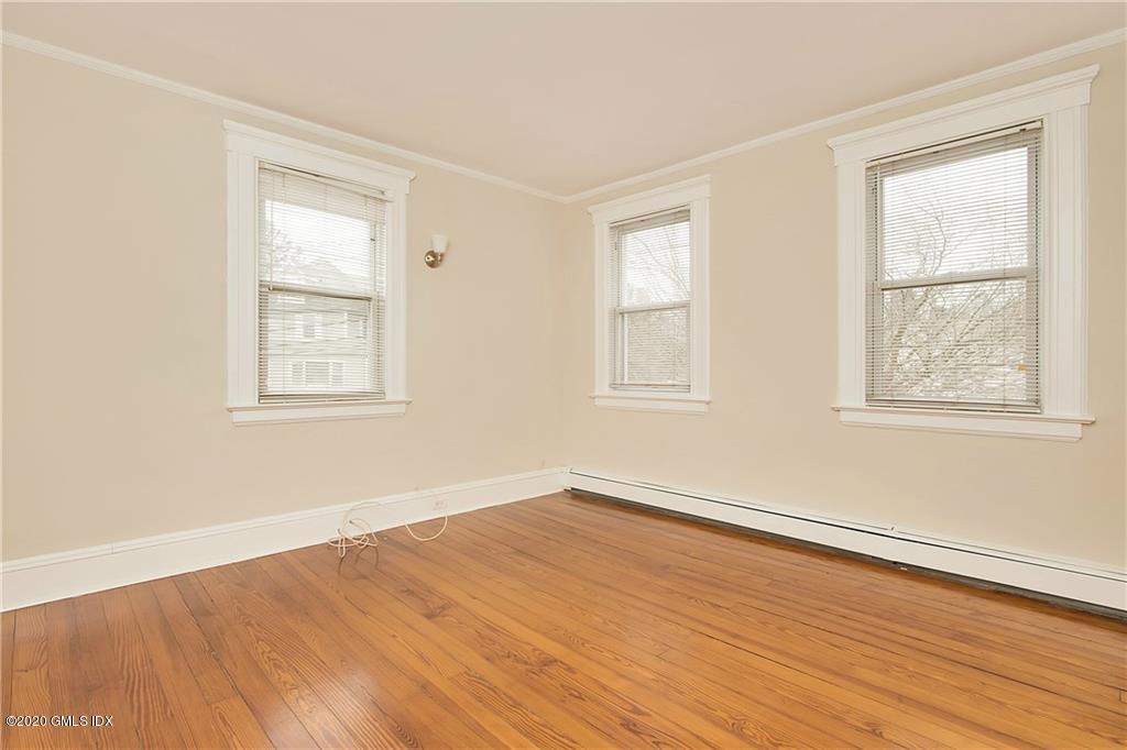 25 Valley Road, Unit 25 Cos Cob, CT 06807 - Photo 8 of 17 an empty room with wooden floor and windows
