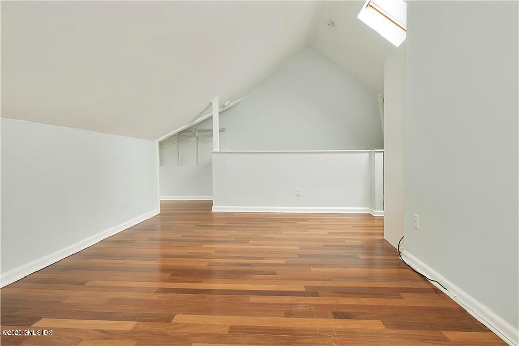 25 Valley Road, Unit 25 Cos Cob, CT 06807 - Photo 10 of 17 a view of an empty room with wooden floor and a window