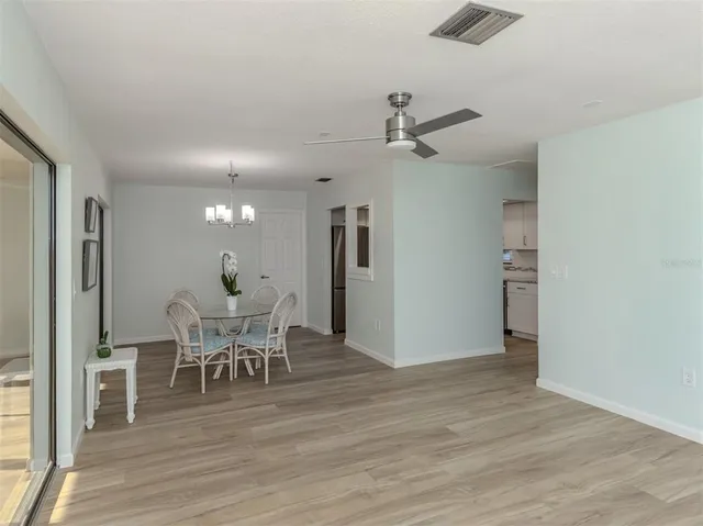 a view of a dining room with furniture and wooden floor