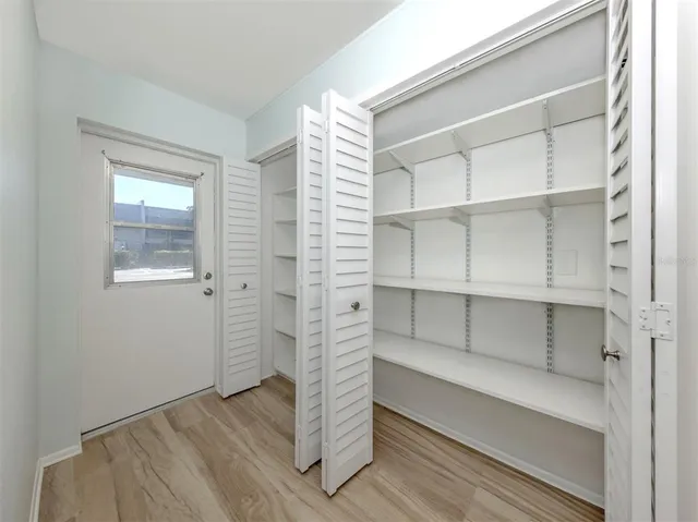 a view of walk in closet with empty racks