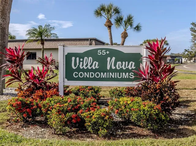 a sign that is sitting in front of flowers