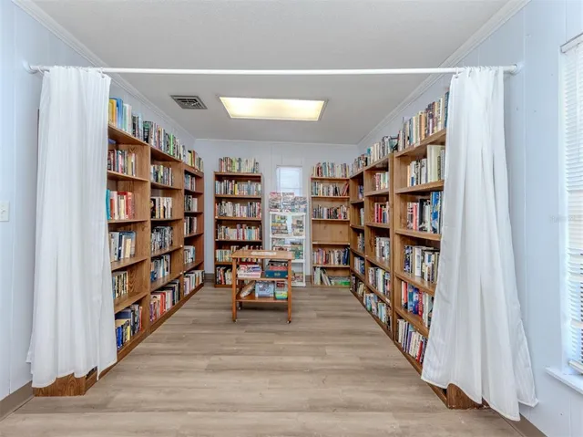 a living room with lots of books and a book shelf