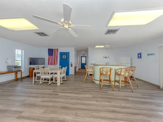 a dining room with furniture and wooden floor