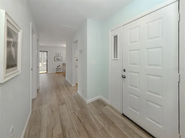 a view of a hallway with wooden floor