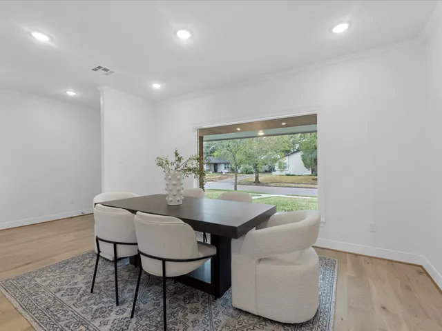 a kitchen with white cabinets and sink
