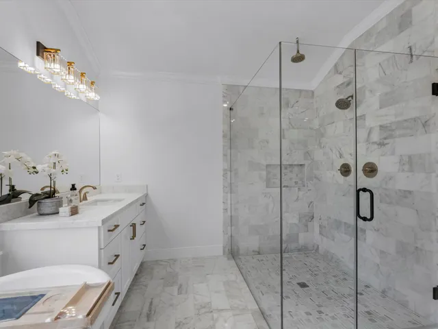 a bathroom with a sink vanity granite toilet and a mirror