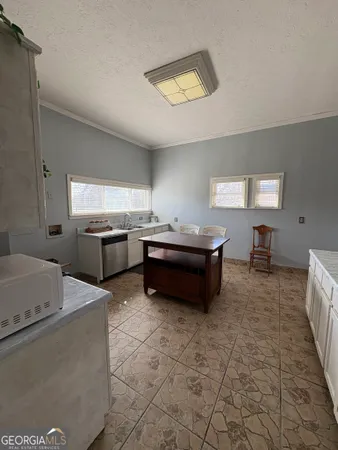 a kitchen with granite countertop a sink and a stove