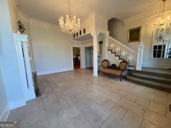 a view of hall way with furniture