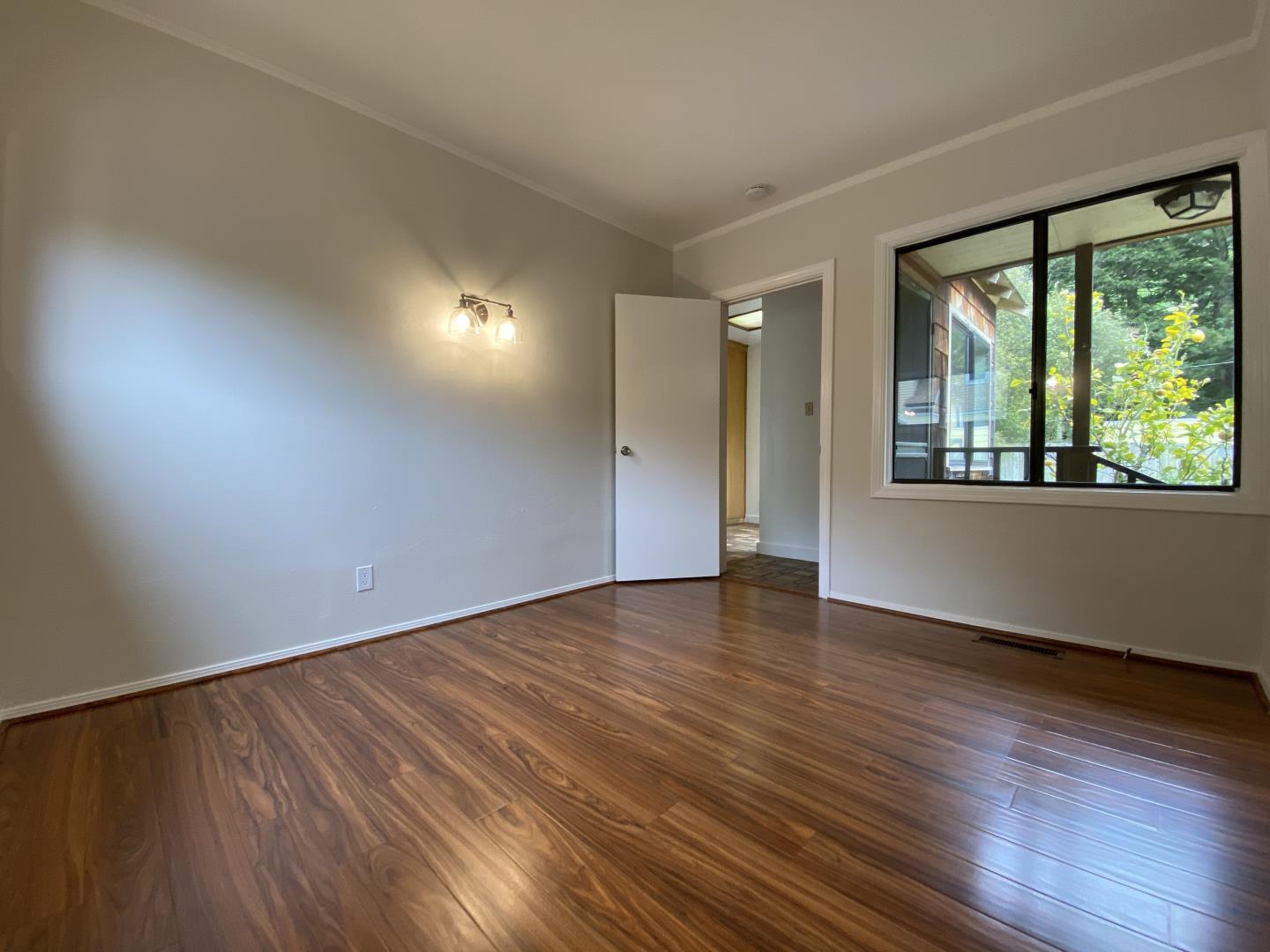 220 Minerva Avenue Pacifica, CA 94044 - Photo 15 of 22 a view of an empty room with wooden floor and a window