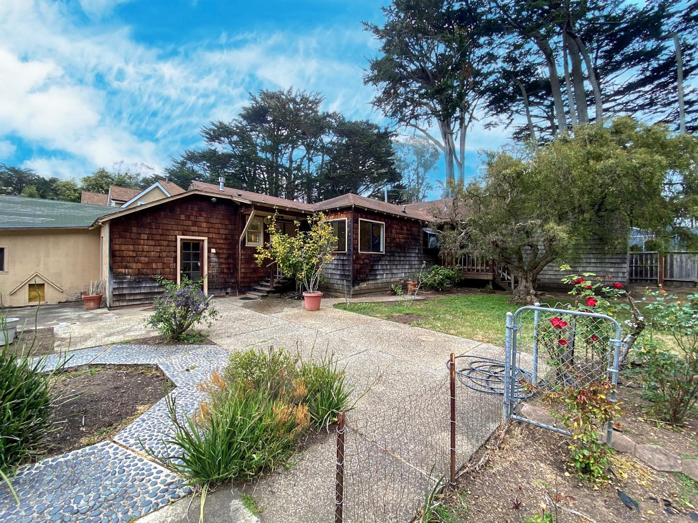 220 Minerva Avenue Pacifica, CA 94044 - Photo 18 of 22 a view of a house with backyard and sitting area