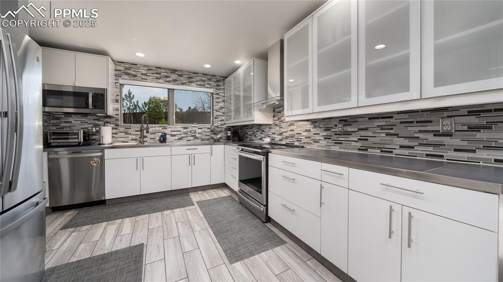 7550 Dairy Ranch Road Colorado Springs, CO 80919 - Photo 12 of 39 a kitchen with stainless steel appliances granite countertop a sink and cabinets