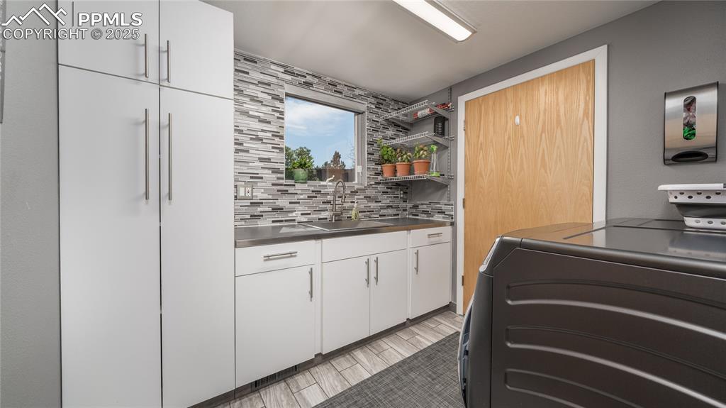 7550 Dairy Ranch Road Colorado Springs, CO 80919 - Photo 13 of 39 a bathroom with a granite countertop sink and a mirror