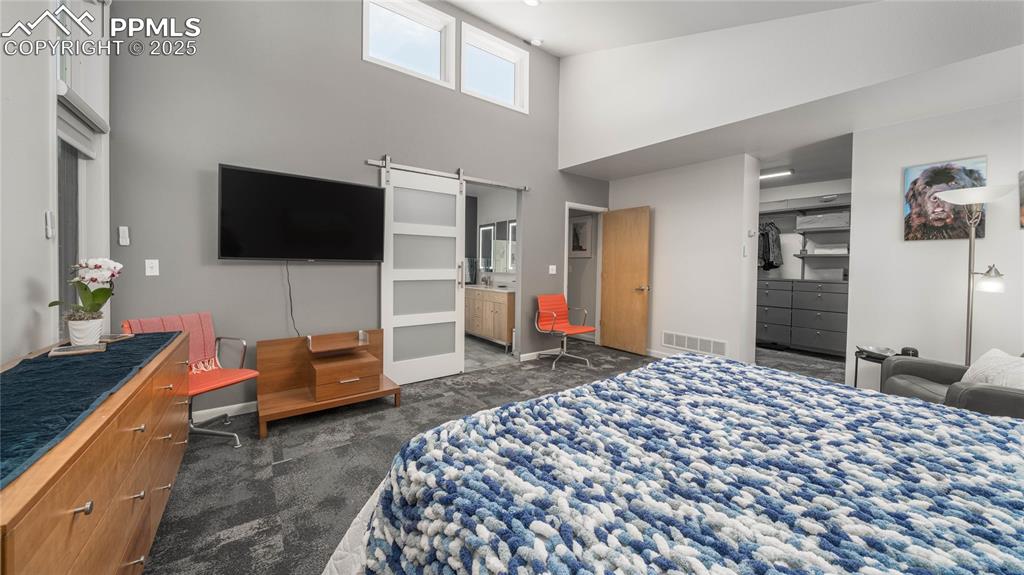 7550 Dairy Ranch Road Colorado Springs, CO 80919 - Photo 15 of 39 a bedroom with a bed and a flat screen tv