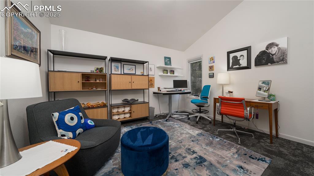 7550 Dairy Ranch Road Colorado Springs, CO 80919 - Photo 20 of 39 a living room with furniture a rug and a flat screen tv
