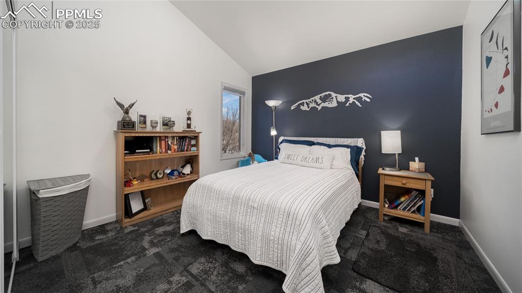 7550 Dairy Ranch Road Colorado Springs, CO 80919 - Photo 22 of 39 a bedroom with a bed and a lamp on dresser