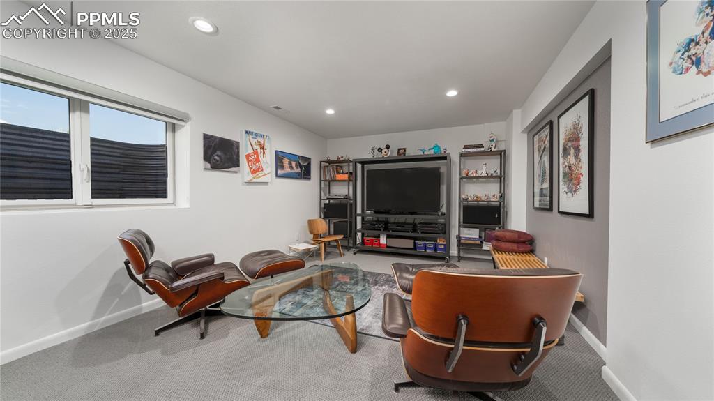 7550 Dairy Ranch Road Colorado Springs, CO 80919 - Photo 27 of 39 a living room with furniture a flat screen tv and floor to ceiling window