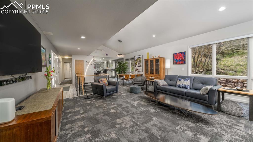 7550 Dairy Ranch Road Colorado Springs, CO 80919 - Photo 6 of 39 a living room with furniture a flat screen tv and a large window