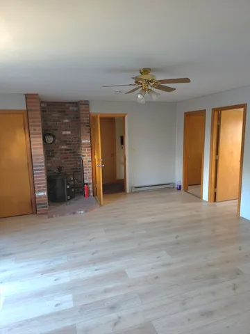 a view of an empty room with a fireplace