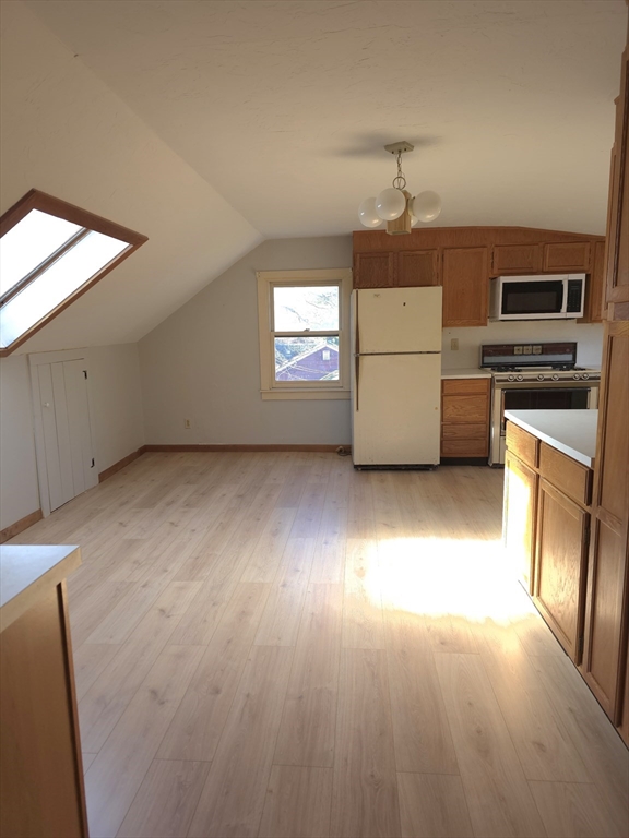 3 Jacobson Drive, Unit 2 Auburn, MA 01501 - Photo 12 of 20 an empty room with a kitchen and a fireplace