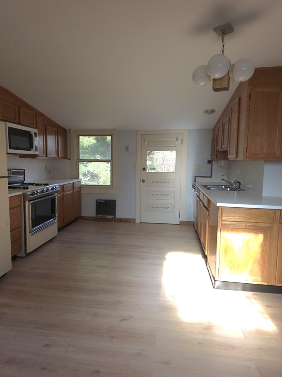 3 Jacobson Drive, Unit 2 Auburn, MA 01501 - Photo 15 of 20 a kitchen with stainless steel appliances granite countertop a stove a sink and a microwave