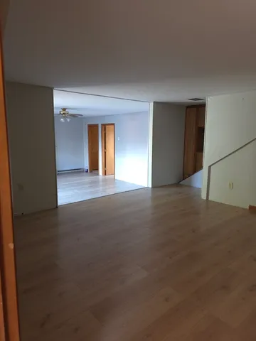 a kitchen with stainless steel appliances granite countertop wooden cabinets a sink a stove a refrigerator with grey cabinets