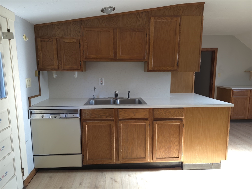3 Jacobson Drive, Unit 2 Auburn, MA 01501 - Photo 19 of 20 a kitchen with stainless steel appliances granite countertop wooden cabinets a sink a stove a refrigerator with grey cabinets