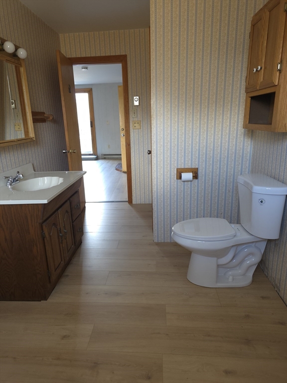 3 Jacobson Drive, Unit 2 Auburn, MA 01501 - Photo 7 of 20 a bathroom with a sink a toilet and mirror