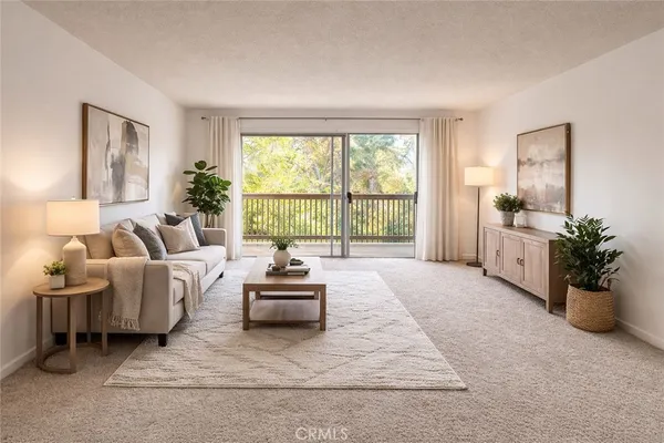a living room with furniture and a potted plant