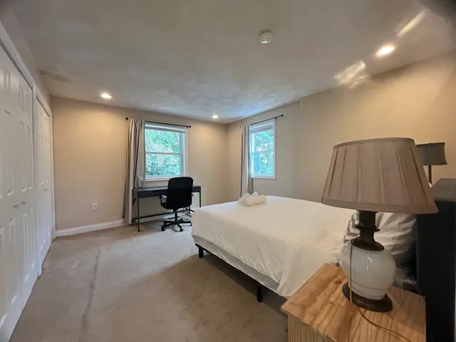 a bed room with a bed and a lamp