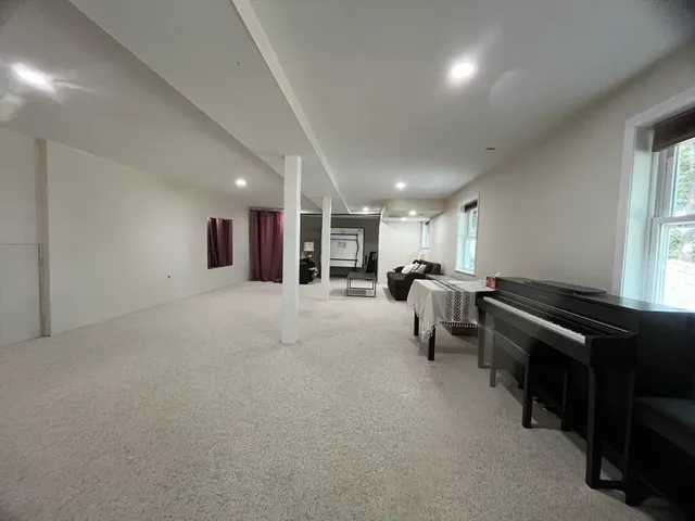 a living room with furniture and a piano