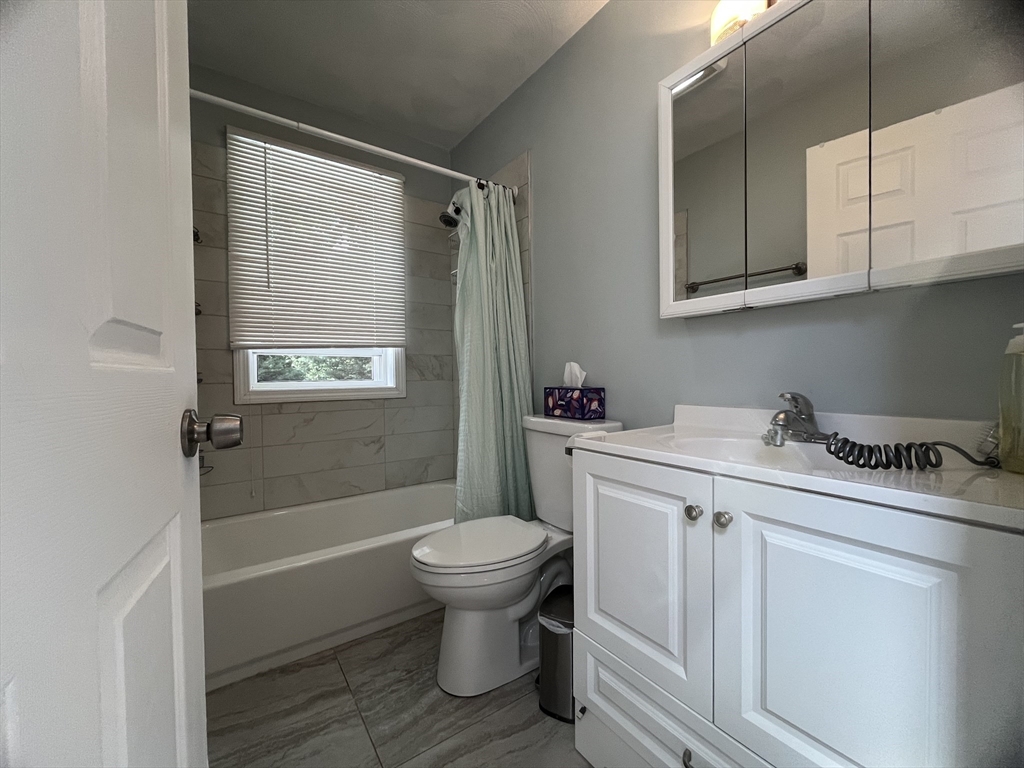 195 Grove Street, Unit 201 Cambridge, MA 02138 - Photo 6 of 20 a bathroom with a sink toilet and shower