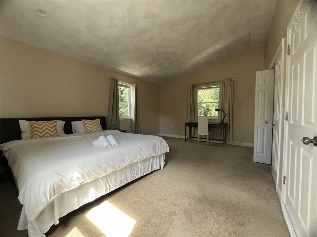 195 Grove Street, Unit 201 Cambridge, MA 02138 - Photo 9 of 20 a spacious bedroom with a bed and window