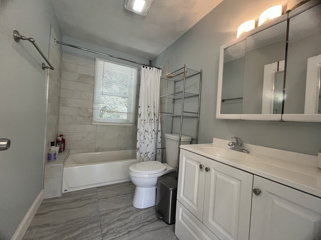 195 Grove Street, Unit 201 Cambridge, MA 02138 - Photo 10 of 20 a bathroom with a sink toilet a mirror and shower