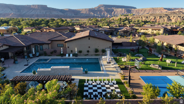 168 South Rancho Santa Fe Virgin, UT 84779 - Photo 5 of 58 Expansive backyard featuring a large swimming pool, integrated spa, artificial turf lawn, a life-sized chess board, and a sports court