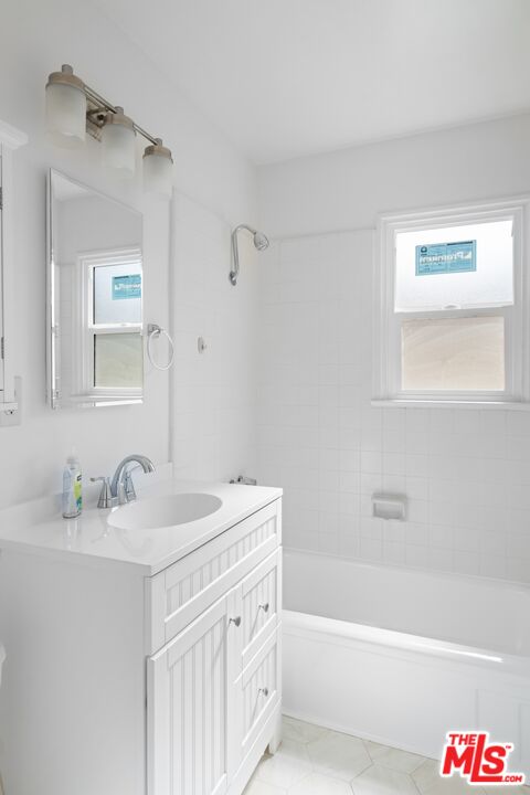 3493 Meier Street Los Angeles, CA 90066 - Photo 19 of 31 a bathroom with a sink a mirror a bathtub and a shower