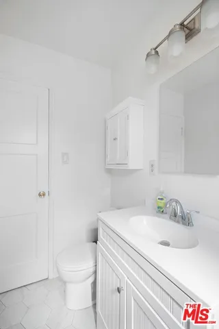 a bathroom with a sink toilet and vanity