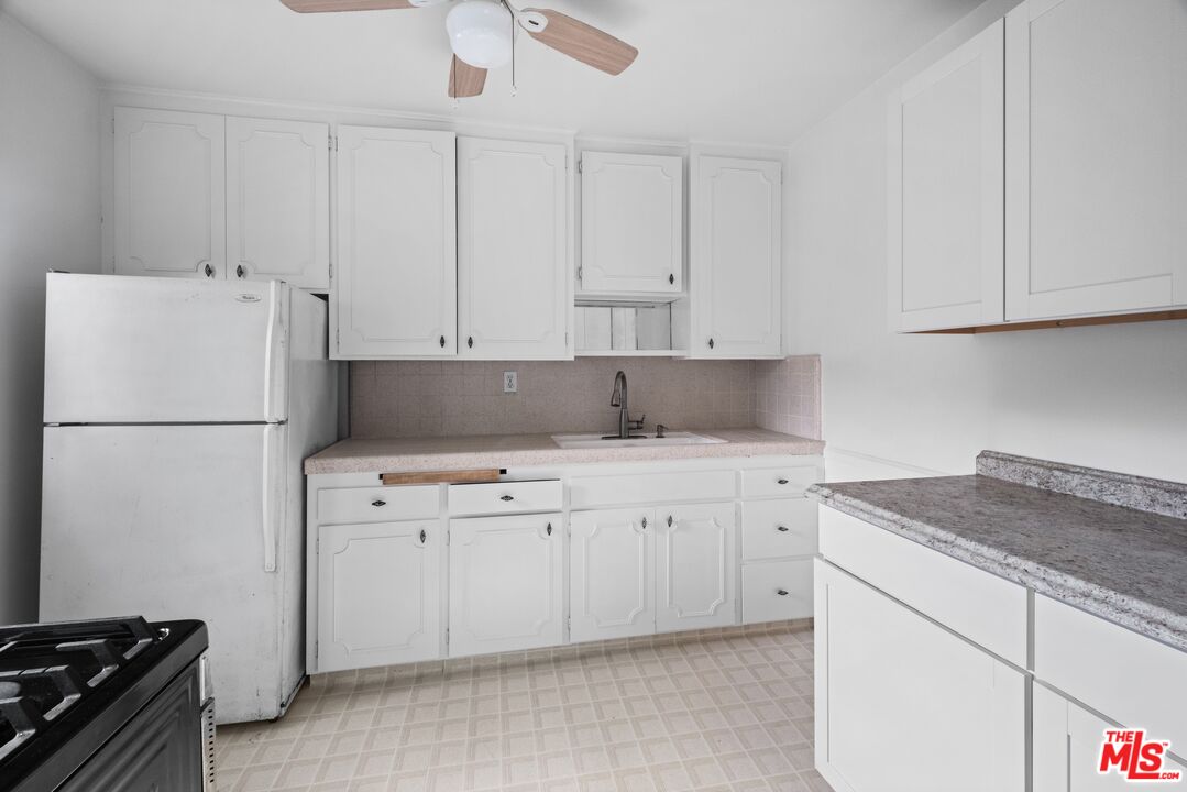 3493 Meier Street Los Angeles, CA 90066 - Photo 3 of 31 a kitchen with cabinets appliances a sink and a counter space