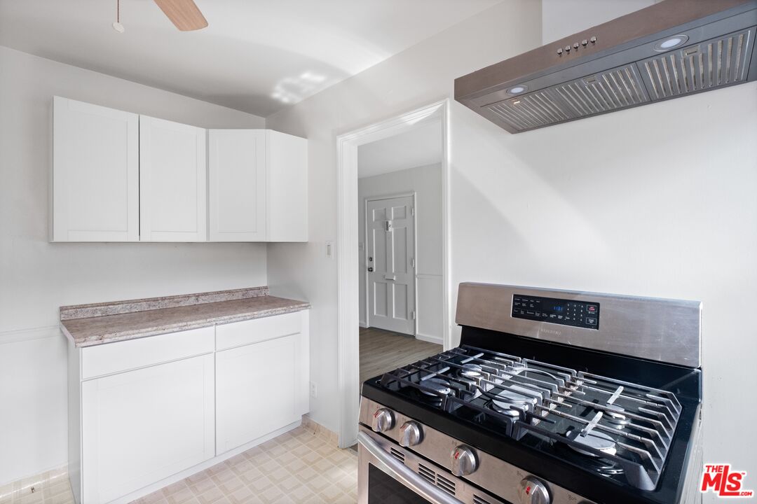 3493 Meier Street Los Angeles, CA 90066 - Photo 5 of 31 a kitchen with white cabinets and appliances