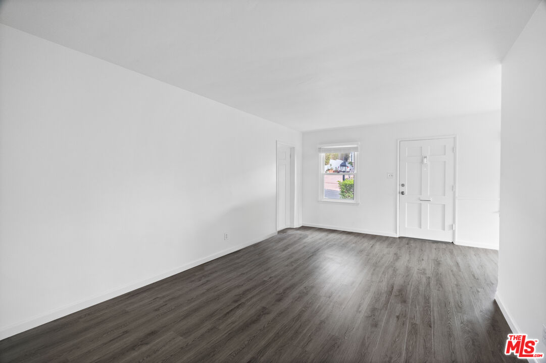 3493 Meier Street Los Angeles, CA 90066 - Photo 7 of 31 an empty room with wooden floor and white walls