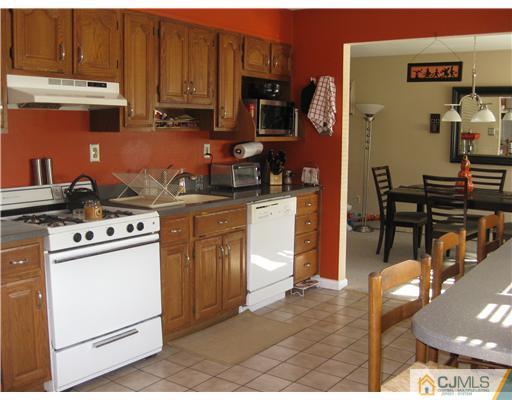 19 Baxter Road Edison, NJ 08817 - Photo 4 of 10 a kitchen with stainless steel appliances granite countertop a stove a sink and a refrigerator