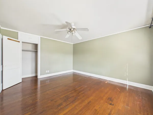 a view of an empty room with wooden floor