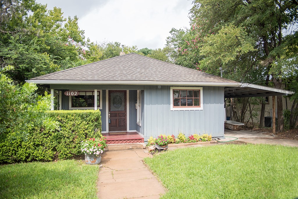 a house with trees in the background