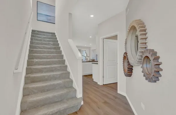 a view of entryway and hall with wooden floor