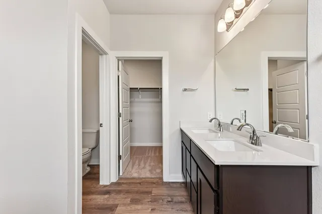 a bathroom with a sink double vanity and a mirror
