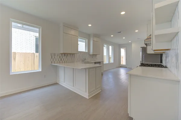 a view of kitchen with windows and dual sinks