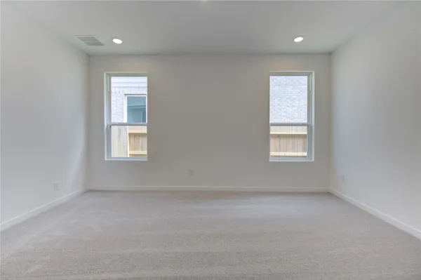 an empty room with windows and closet