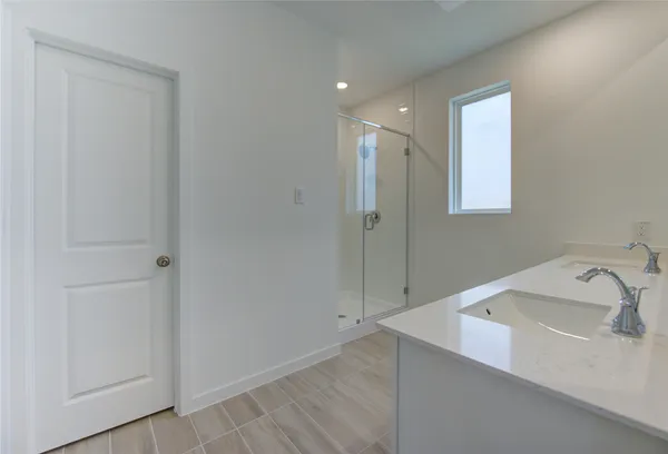 a bathroom with a double vanity sink and a mirror